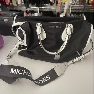 Michael Kors black and white crossbody with top handles.